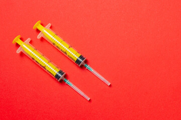 Top view of different syringes for injection on colorful background. Medical equipment concept with copy space