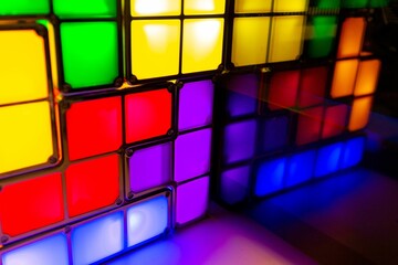 Close-up shot of illuminated colorful blocks reflecting in a mirror
