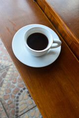 Espresso coffee on dark wooden table. 