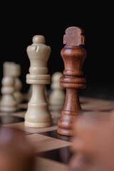 Vertical shot of chess figures - the concept of overcoming the challenges and succeeding