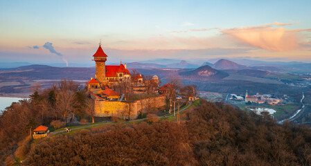 Neo-Gothic castle Hněvín at sunset. Dominant of the city of Most. Taken by drone. Lake Most and...