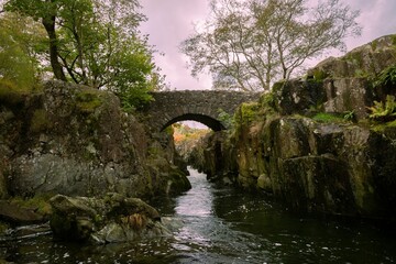 River flowing under an old stone bridge