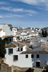 Vertical shot of the beautiful white buildings and houses in Rondo Spain on a sunny day