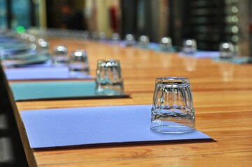 Closeup of a row of glasses on a wooden table.