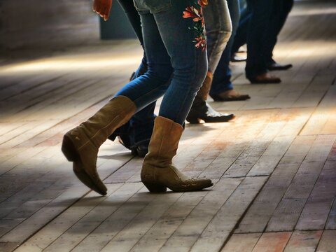 Closeup shot of the legs of traditional western folk dancing under the music