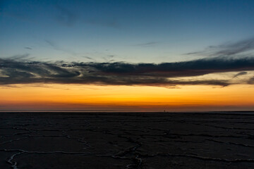 Sunset or sunrise on salt lake Elton (Russia) Tall altocumulus and cirrocumulus clouds against the...