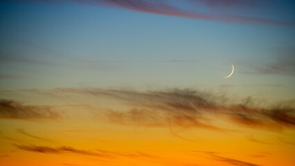 Beautiful view of the Waxing Crescent Moon on a sunset sky