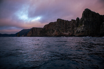 View of the rocky cliffs in the water at sunrise in Cape Hauy Tasmania
