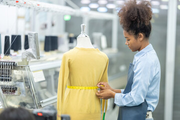 The work of an American female designer seamstress at a computerized sewing machine industrial...