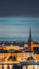 Stockholm, Sweden. Scenic View Of Stockholm Skyline At Summer Evening. Famous Popular Destination Scenic Place In Dusk Lights. Riddarholm Church In Night Lighting.