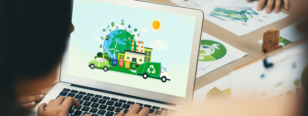 Green city and waste management illustrate displayed on laptop. Business team presenting green...