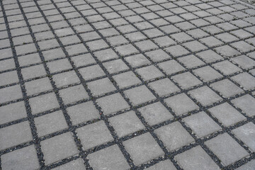 Outdoor drainage floor material. permeable gray paved road from concrete pavers