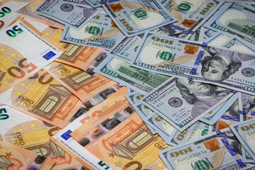 Closeup view of one hundred dollars banknote with euro money banknotes around as financial background.3