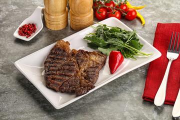 Grilled chuck roll steak with arugula