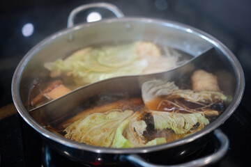 Close up shabu pot, Japan food hotpot two styles of shabu soup. 2 in 1 soup in shabu pot .