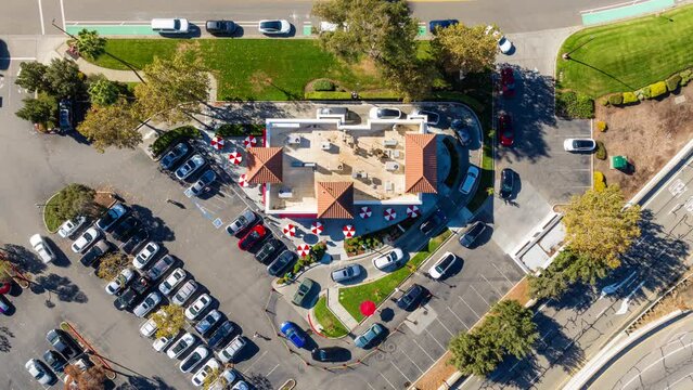 Fast Food Restaurant Cars in Drive Thru. Top Down Aerial Time Lapse View in Day.
