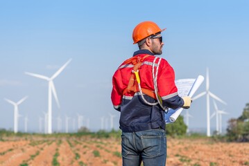 Male man engineer inspection posing check control wind power machine in out door wind energy...