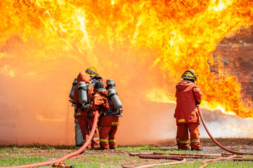 firefighter training new fireman team stop Fire from oil plant blast explode. Fire fighter sprinkle...