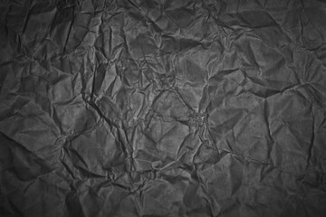 Naklejka premium Crumpled black paper texture background for graphic design and web design