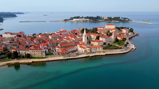 Aerial shot of beautiful Porec old town with Euphrasian Basilica. Flying over Porec, Istria, Croatia before sunrise