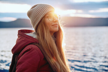 Pretty smiling woman in warm clothes travelling outdoor