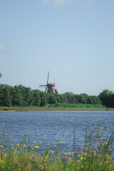Nature landscape in the Netherlands, water and old windmill, no hills
