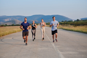 Fototapeta premium A group of friends maintains a healthy lifestyle by running outdoors on a sunny day, bonding over fitness and enjoying the energizing effects of exercise and nature
