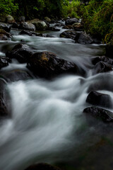 Naklejka premium Stream water long exposure shot with rocks