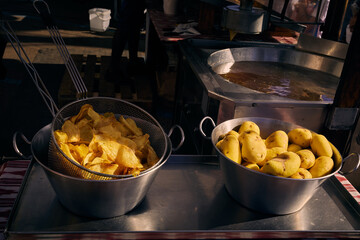 Making and selling potato chips on the street at sunny day in Lloret de Mar, Spain. Street food.