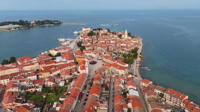 Aerial view of Porec town, Istria, Croatia. Old town with red tiled roofs surrounded by the Adriatic Sea