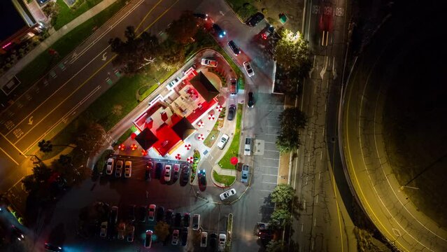 Fast Food Restaurant Cars in Drive Thru. Top Down Time Lapse View at Night.
