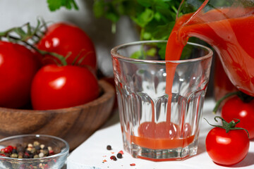 fresh tomato juice poured into a glass