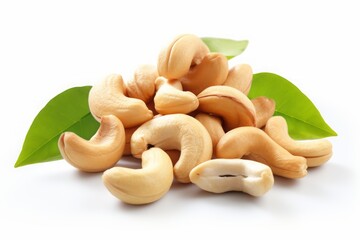 cashews. bunch of peeled nuts with leaves on a white background. healthy vegan snack.