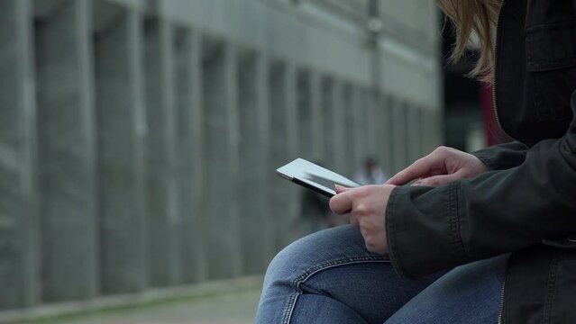 cute young woman sitting in the city using tablet computer: mobile, wi-fi, 4g 