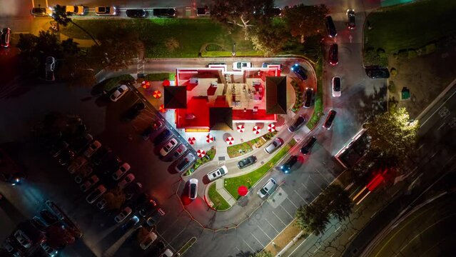 Fast Food Restaurant Cars in Drive Thru. Top Down Time Lapse View at Night.