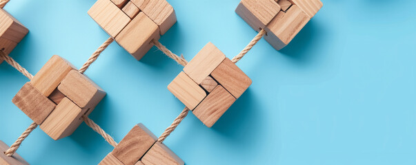 Wooden blocks connected by ropes on blue background