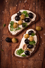 Breakfast, sandwiches, with cream cheese, olives, top view,