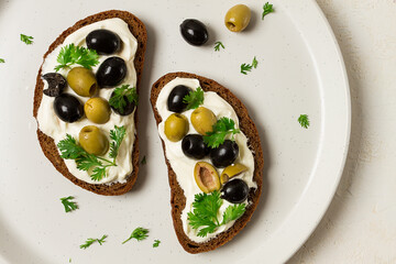 Breakfast, sandwiches, with cream cheese, olives, top view,