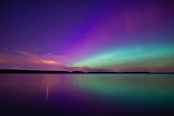 Northern light dancing over calm lake in north of Sweden.Farnebofjarden national park. - obrazy, fototapety, plakaty