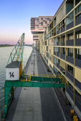 Promenade at the Rhine Harbor in Cologne, Germany: Modern apartment and office buildings line the formal industrial harbor
