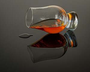 Spilled bourbon glass on black reflective table