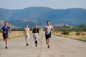 A group of friends maintains a healthy lifestyle by running outdoors on a sunny day, bonding over fitness and enjoying the energizing effects of exercise and nature - 774164069