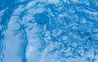 Closeup​ blur​ abstract​ of​ surface​ blue​ water. Abstract​ of​ surface​ blue​ water​ reflected​ with​ sunlight​ for​ background.Top​ view​ of blue​ water - 774169018