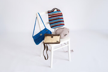 Assorted Handmade Crochet Bags on White Wooden Chair