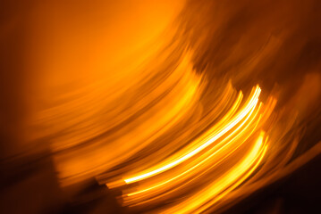 abstract background with bright orange lights on dark, long exposure 