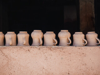 Fototapeta na wymiar Ceramic vases placed on clay wall