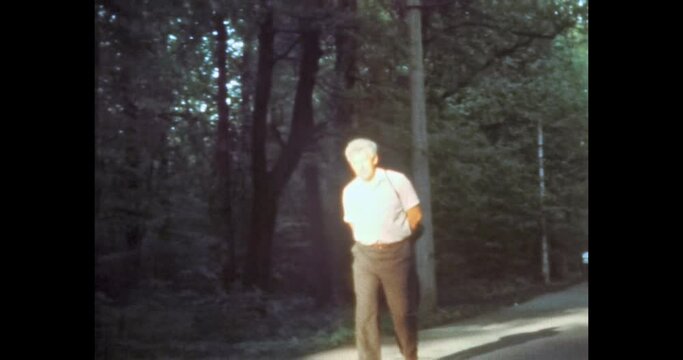 Lonely man in summer sunlight park. Person loneliness in middle age. Walk in city forest. People depression. Sad, exhausted man. Archival vintage color film. Archive video. Retro 1980s Moscow, Russia