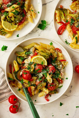 Pasta Primavera, vegetables pasta with zuccini, tomato  and lemon .top veiw.selective focus