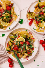 Pasta Primavera, vegetables pasta with zuccini, tomato  and lemon .top veiw.selective focus