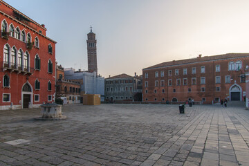 Fototapeta na wymiar Campo San Anzolo square and the bell tower of the Stanto Stefano Church on a sunny winter evening, Venice, Veneto, Italy